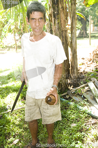 Image of man cutting fresh coconut Nicaragua Corn Island Central America