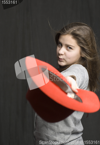 Image of Girl is throwig a red hat