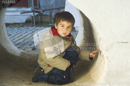 Image of Little kid in a stone tube