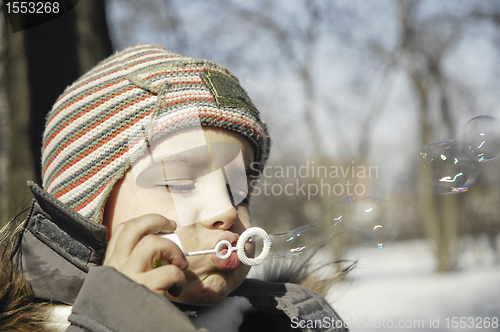 Image of BOY BLOWING BUBBLES