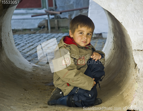 Image of Little kid in a stone tube