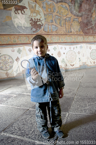 Image of Boy in church with big old key