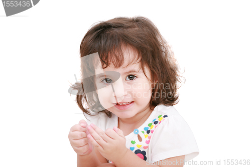 Image of 2 years old girl smiling and looking at the camera