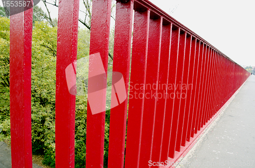 Image of Bridge railing painted red background closeup 