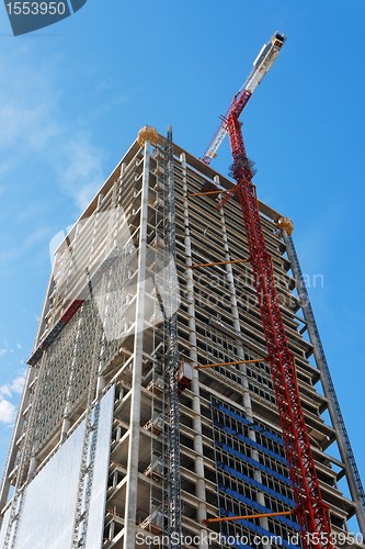 Image of Lifting crane and high building under construction 