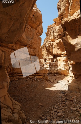 Image of Narrow slot between two rocks in desert canyon