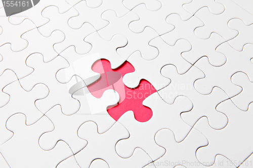Image of puzzle with missing parts, which are connected