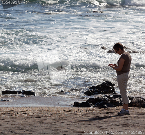 Image of Woman beachcomb on Glass Beach