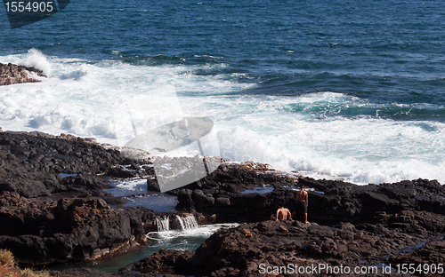 Image of Two boys looking to jump into ocean