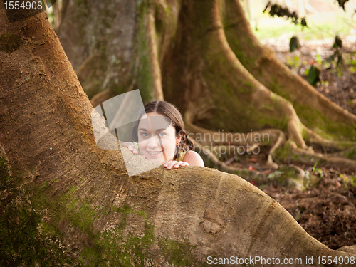 Image of Girl peeping from behind Moreton Fig