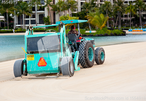 Image of Sweeping and raking sand on beach