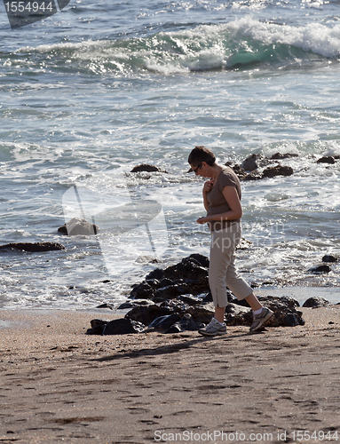Image of Woman beachcomb on Glass Beach