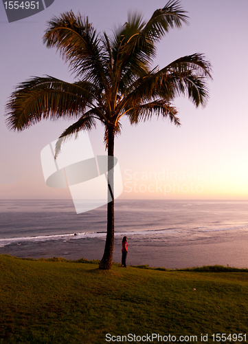 Image of Woman watching sunrise in Kauai