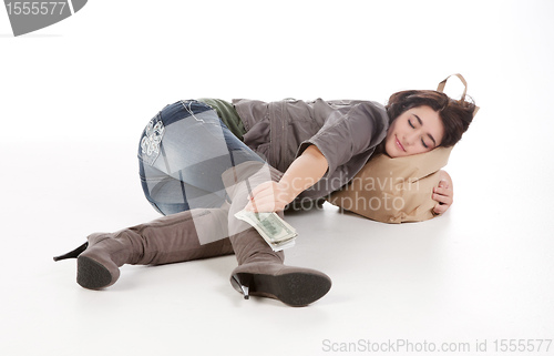 Image of young woman with shopping and cash