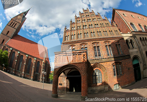 Image of Old city hall in Hanover, Germany, built in the common brickwork style of northern Germany (Northern German Brickstone Gothic, 15th century). The building on the left is the Marktkirche.