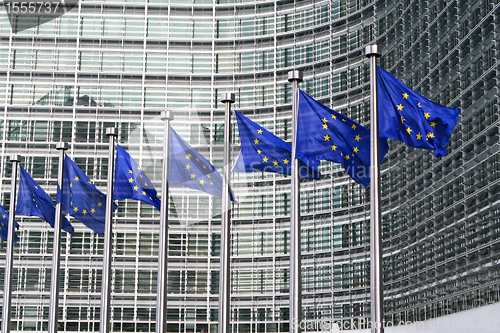 Image of European flags in front of the European Commission headquarters in Brussels, Belgium.