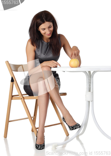 Image of Girl with apple sitting