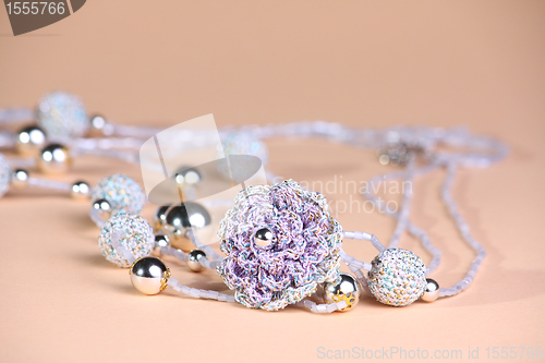 Image of Violet beads at pink background