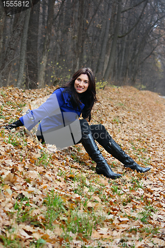 Image of Young woman in the autumn park