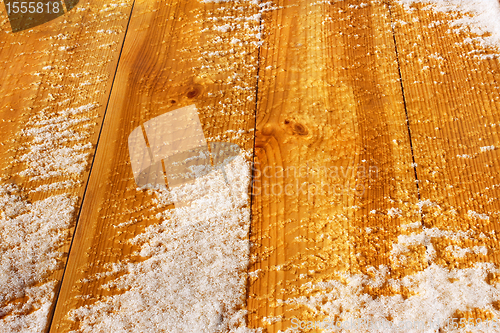 Image of Wooden shield covered with snow