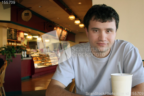 Image of Man sitting in a coffee shop