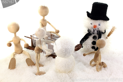 Image of Family builds a snowman