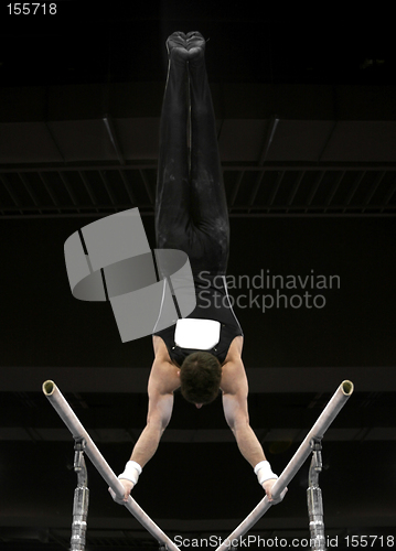 Image of Gymnast doing handstand on parallel bars