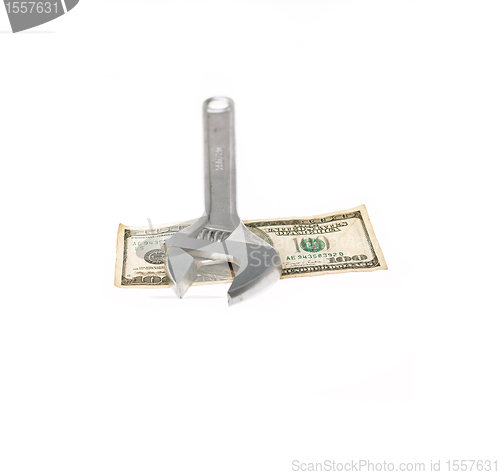 Image of wrench and dollar bill isolated on white