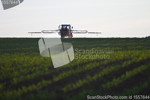 Image of tractor with pesticide on field