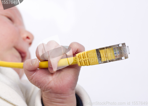 Image of baby holding network cable