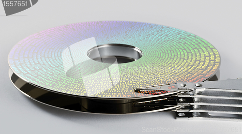 Image of parts of hard disk drive with information on magnetic surface