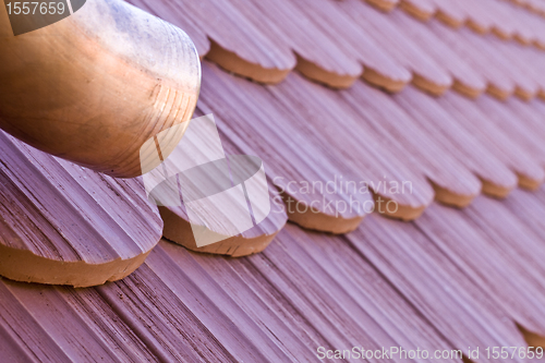 Image of roof tile with part of eaves gutter