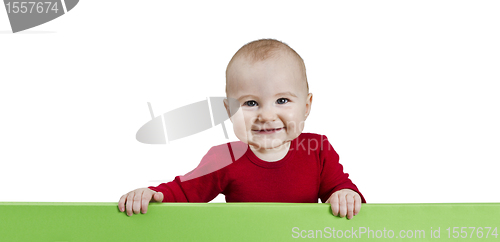 Image of young child holding green sign