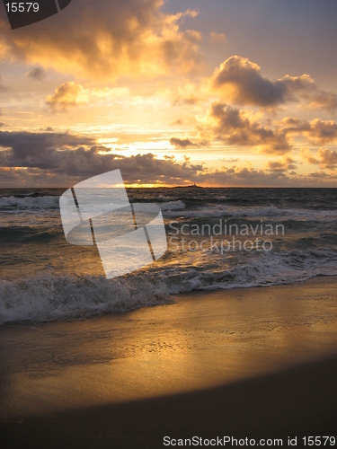 Image of Sunset at beach with an isle in the horizon