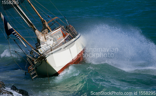 Image of yacht crash on the rocks in stormy weather 