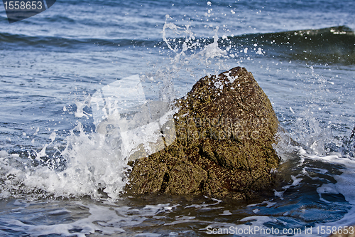 Image of small rock in waves