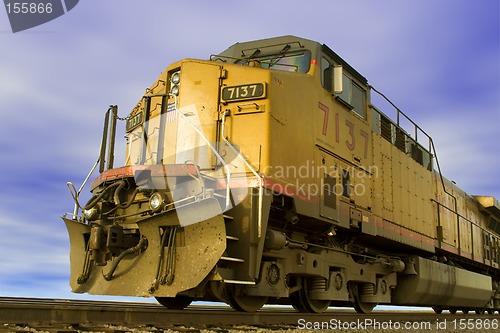 Image of yellow train with vivid blue sky