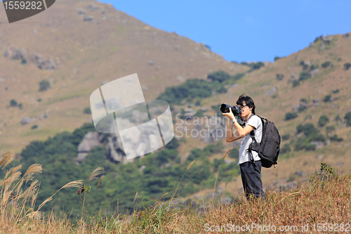 Image of photographer taking photo in country side