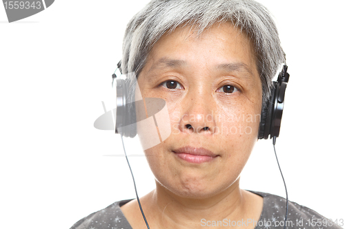 Image of mature woman listen music