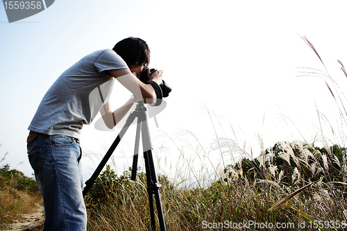 Image of photographer taking photo in country side