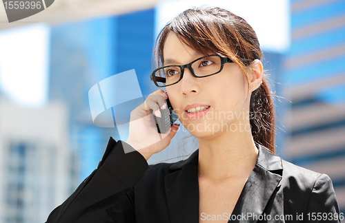 Image of young business woman with mobile phone
