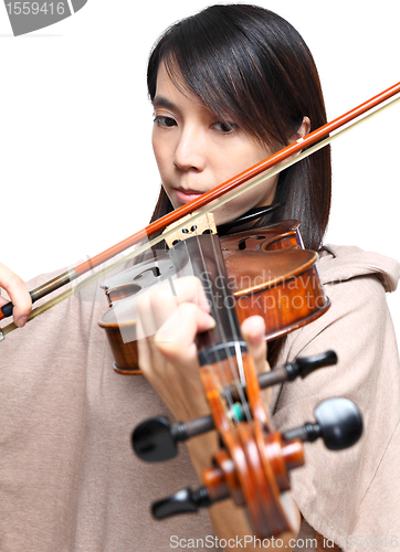 Image of Young woman play violin