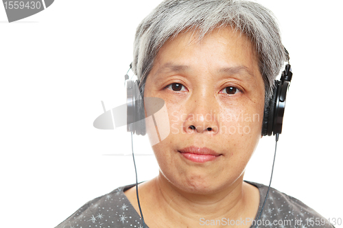 Image of mature woman listen music