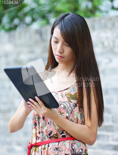 Image of young woman using tablet touch computer