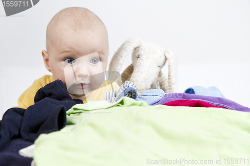 Image of young cild with washing and toy