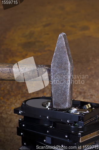 Image of hammer on stack of hard disk