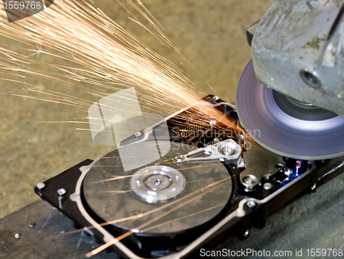 Image of grinder working on open hard drive