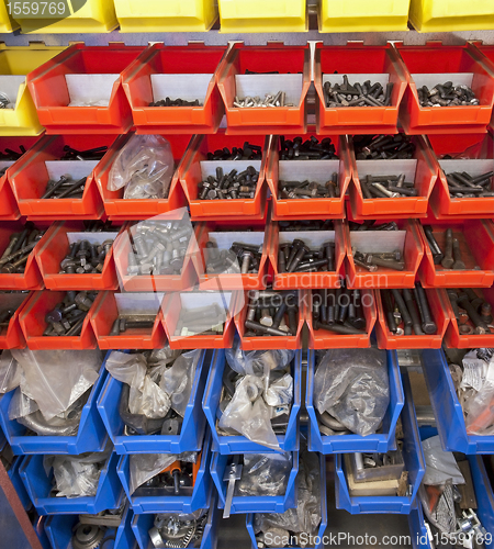 Image of many bolts in colored drawer