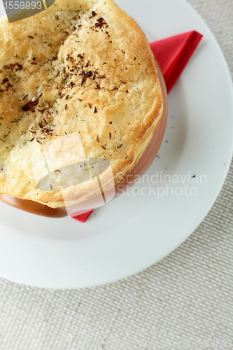 Image of pancake on brown pot