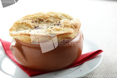 Image of pancake on brown pot